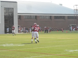 Linebacker Trey Depriest makes a tackle during Alabama's Tuesday football practice. (Photo by Brett Hudson)