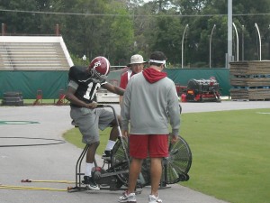 Cornerback Bradley Sylve works on the exercise bike as he sits out of monday's practice. (Photo by Brett Hudson)