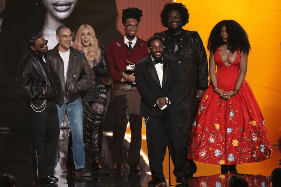 Kendrick along with SZA, Kendricks producers, and Cher accepting another Grammy.